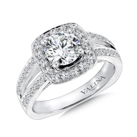 A wonderful split shank engagement ring with a cushion shape halo of diamonds surrounding the round center stone. 