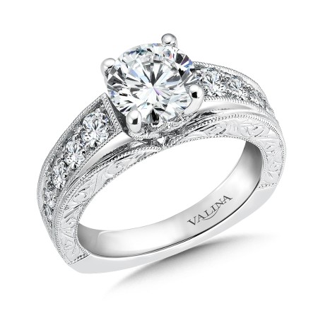 Hand engraved engagement ring with side diamonds set in 14k white gold.