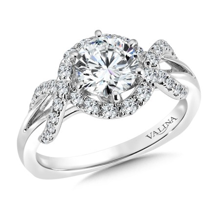 Split shank halo-style diamond engagement ring set in 14k white gold.