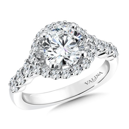 Round halo-style diamond engagement ring set in 14k white gold.